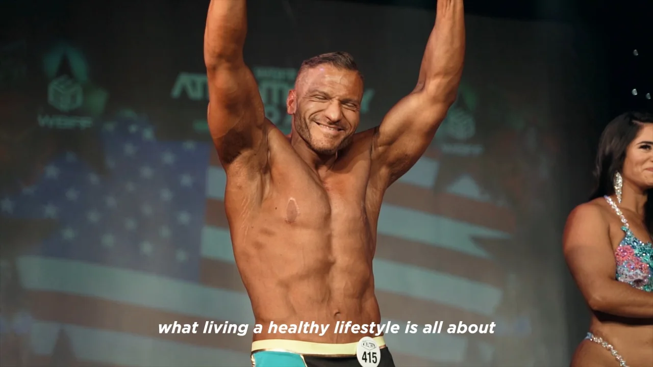 Anthony Lolli on stage after losing 124 pounds